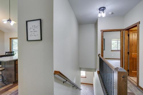 a staircase in a house with a picture on the wall at Family-Friendly Lead Cabin Near ATVandSnowmobiling in Lead