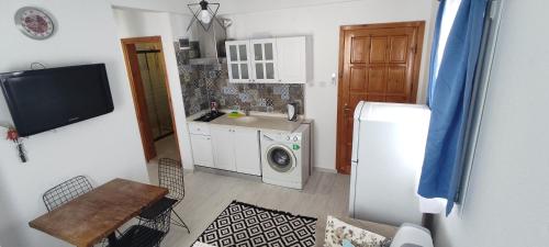a kitchen with a washer and a sink and a refrigerator at Apart Turgutreis in Turgutreis