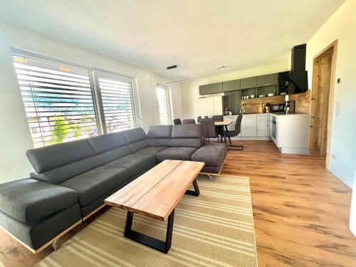 a living room with a couch and a table at Alpin Apartments in Radstadt