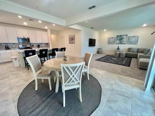 a kitchen and living room with a table and chairs at Brand-New, Beautiful & Stylish Home in Sacramento! in Sacramento