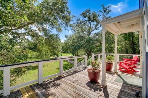 a porch with red chairs and a gazebo at Charming Bay St Louis Home Deck, on Canal! in Shoreline Park