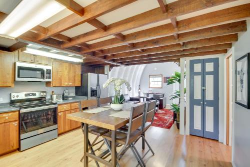 a kitchen with wooden cabinets and a table with chairs at Charming Bay St Louis Home Deck, on Canal! in Shoreline Park