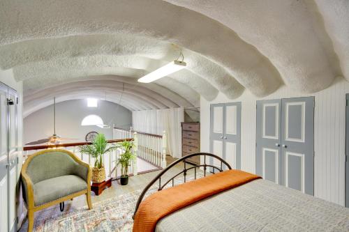 a bedroom with a bed and a chair at Charming Bay St Louis Home Deck, on Canal! in Shoreline Park