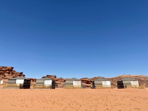 a row of beach huts in the desert at Desert's Soul Wadi Rum in Disah