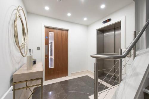 a hallway with a staircase and a mirror at Urban Chic Central Studio in Reading Centre CHRL F7 in Reading