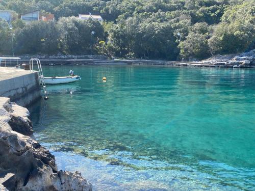 a boat is docked in a body of water at Happy Day in Osobjava
