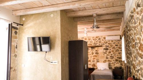 a room with a tv on the wall and a bed at Mitato Eagle's Nest Peristeres in Níthavris