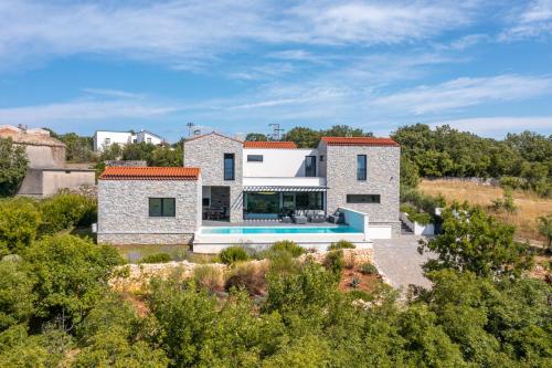 an aerial view of a house with a swimming pool at Cà Veia in Vrbnik