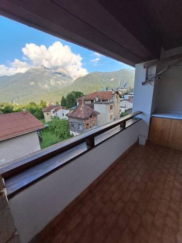 a room with a large window with a view at Il tuo nido sulle Dolomiti, con vista panoramica! in Calalzo