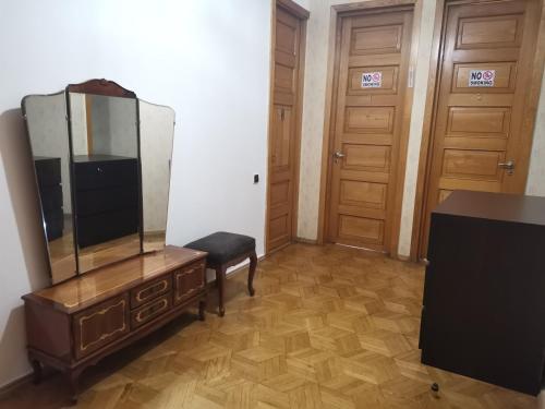 a room with a dresser and a mirror and two doors at EUROPEAN Backpackers Hostel in Tbilisi City