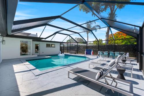 a swimming pool with a glass roof over it at Casa Grandè in Clearwater