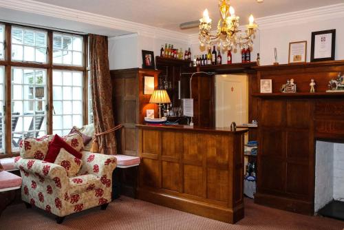 a living room with a chair and a fireplace at Kersbrook Guest Accommodation in Lyme Regis