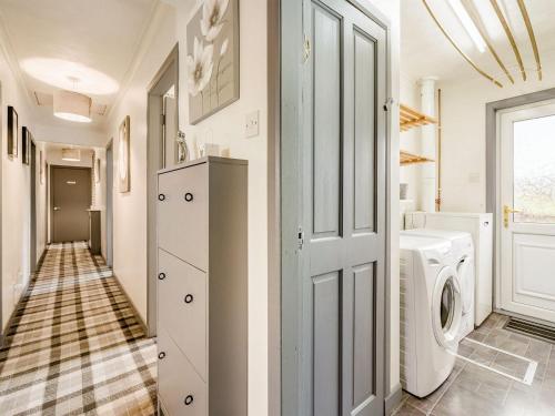 a laundry room with a washer and dryer at Highview in Brodick