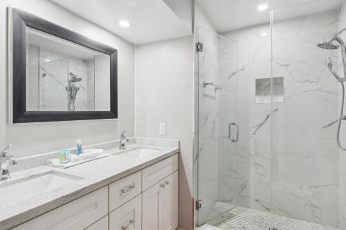 a bathroom with a shower and a sink and a mirror at Stunning Miami Oasis with Private Furnished Patio! in Miami Gardens