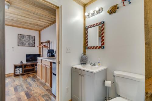 a bathroom with a white toilet and a sink at Norfork Studio Cabin Fishing, Kayaking and More! in Norfork