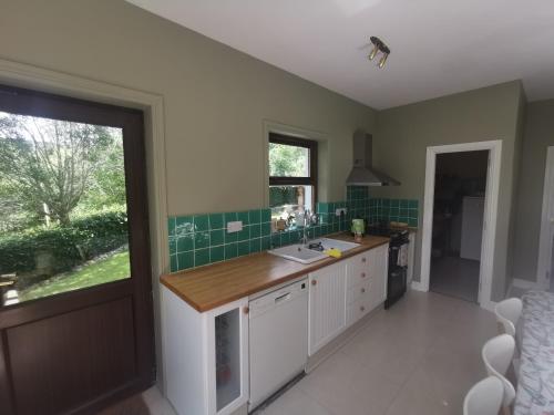 a kitchen with a counter and a sink and a window at Blue Stack View in Edergole Bridge