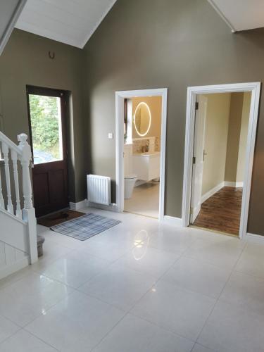 a living room with a door and a hallway at Blue Stack View in Edergole Bridge