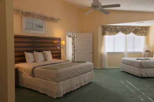 a bedroom with two beds and a ceiling fan at Wildwood Crest Beach House in Wildwood Crest