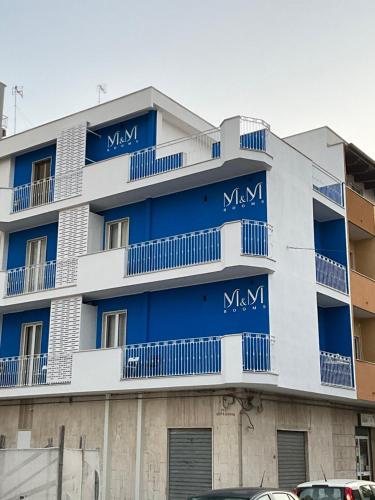 a blue and white building with blue balconies at M&M rooms Margherita di Savoia in Margherita di Savoia