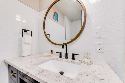 a bathroom with a sink and a mirror at Taos Motor Lodge in Taos