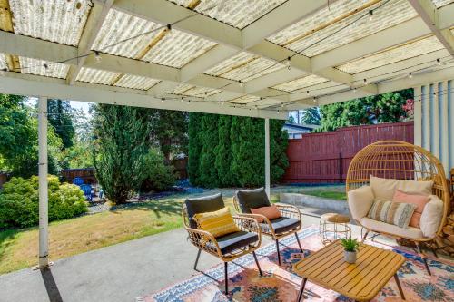 a patio with chairs and a table and awning at Updated Tacoma Home with Fire Pit! in Tacoma