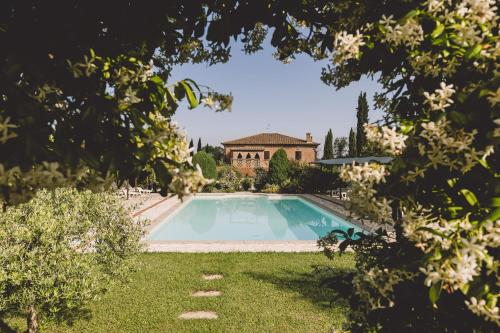 a large swimming pool in front of a house at Villa Nobile Cortona in Cortona