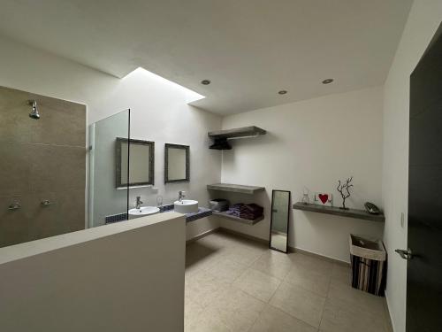 a large bathroom with a sink and a shower at Zen Home in Tulum