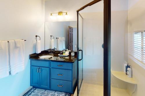 a bathroom with a blue cabinet and a sink at Abruzzi - Villa B in Eatonton 