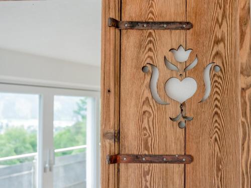 a wooden door with a heart design on it at Josef Konrad in Helfenstein