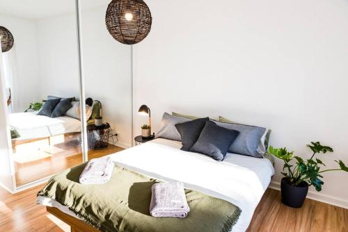 a bedroom with a bed and a mirror at Beachfront Escape in Port Adelaide