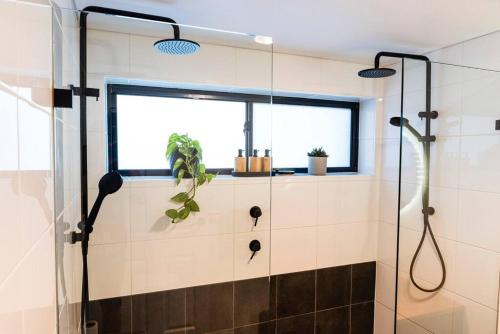 a bathroom with a shower and a window at Beachfront Escape in Port Adelaide