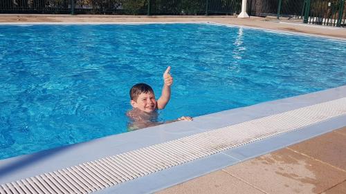 a boy in a swimming pool giving a thumb up at Aqua bussy in Bussy-Saint-Georges
