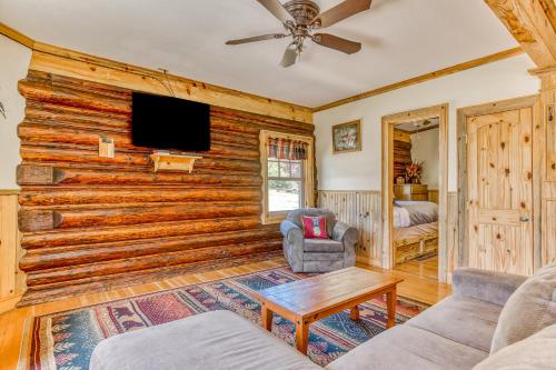 a living room with a log wall at The Logs Deer Room in Snowden