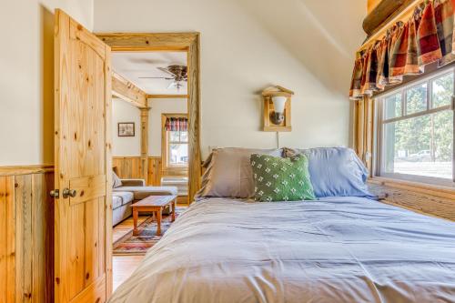 a bedroom with a bed and a large window at The Logs Deer Room in Snowden