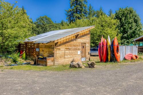 a small wooden building with surfboards leaning against a fence at The Logs Deer Room in Snowden