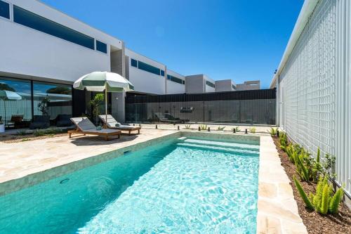 a swimming pool in the backyard of a house at Reef House: Pool • Beachfront • Near Wineries in Aldinga Beach