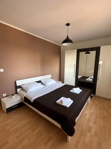 a bedroom with a large bed and a mirror at Relax and Unwind: Family-Friendly House near Zadar in Zagrad in Zadar