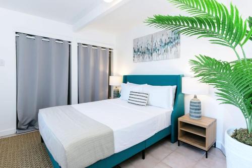 a bedroom with a bed and a plant at Ocean View Retreat Villa in Enighed
