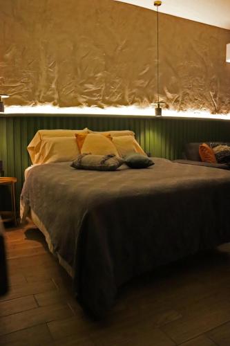a bed with two pillows on it in a room at Layoo, Tu casa en Oaxaca 102 in Oaxaca City
