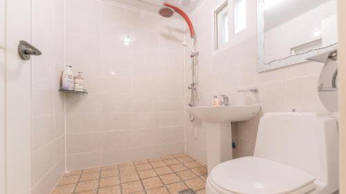 a bathroom with a toilet and a sink at Tinkerbell Pension in Gyeongju