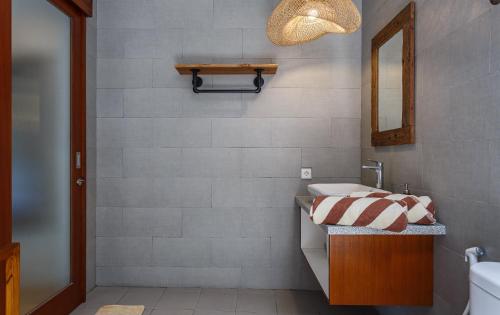 a bathroom with a sink and a mirror at Canggu Hype in Canggu