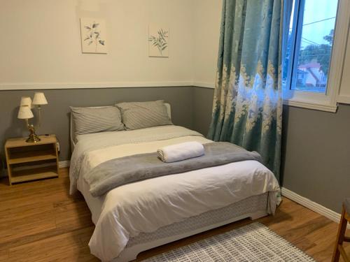 a small bedroom with a bed and a window at Entire 2-bedroom bungalow in Cornwall