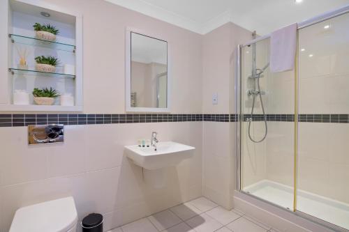 a white bathroom with a shower and a sink at Lyter Living-The Foundry-Jericho-Oxford-Parking Included in Oxford