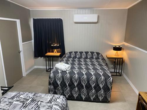 ein Wohnzimmer mit einem Sofa und einem Bett in der Unterkunft Rix Hotel Motel in Charters Towers