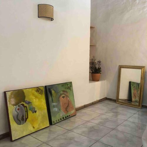 three framed paintings on a wall next to at Casa Tranquila Barrada in Alcoutim