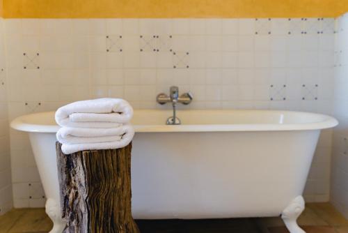 a white bath tub with towels on top of it at Cap de Castel in Puylaurens