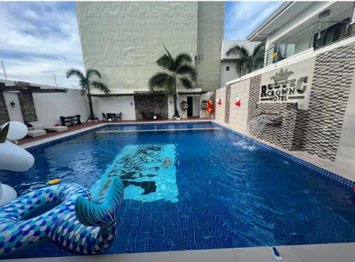 a large swimming pool in a hotel at Rustic Crown Hotel in Alaminos
