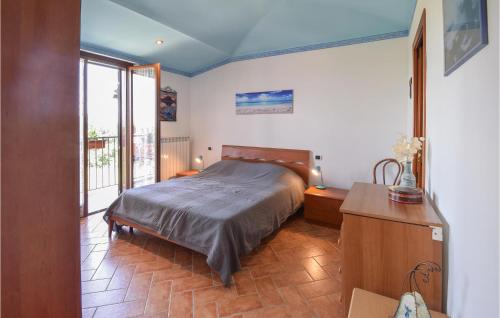 a bedroom with a bed and a large window at Amazing Apartment In Montefiascone With Wifi in Montefiascone