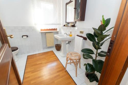 a bathroom with a sink and a toilet and a stool at Villa Ninetta in Bucchianico