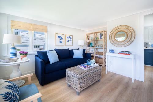 a living room with a blue couch and a table at Marina Bay Cottages in Waterford
